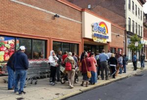 shoppers outside of Bravo grocery store