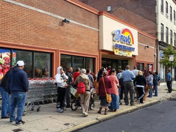 shoppers outside of Bravo grocery store